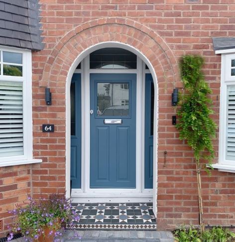 a door step with cobalt blue tiles, matching the pretty cobalt blue front door