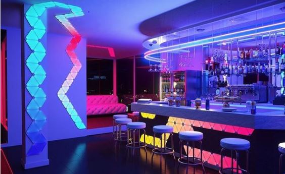 a modern bar with cool, modular lighting in various colours