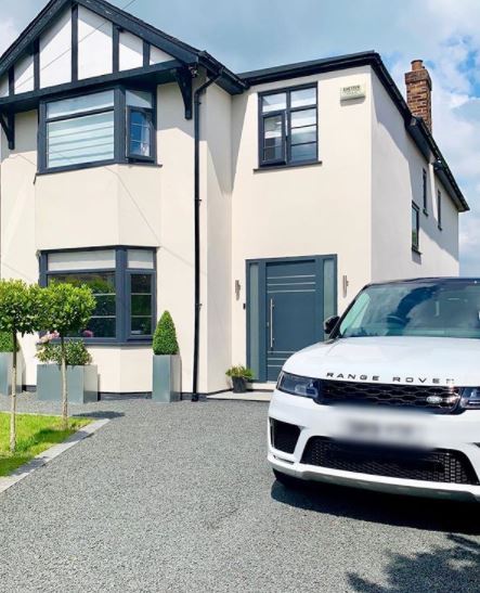 a renovated Victorian home with an extended gravel driveway