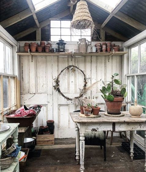 a rustic, shabby chic potting shed made from reclaimed materials
