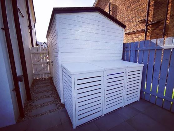 bin storage ideas next to a shed, painted the same colour to blend in