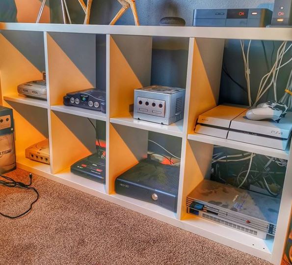 man cave shelving, with each shelf housing a different games console