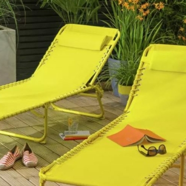 two bright yellow sun loungers made from metal and fabric