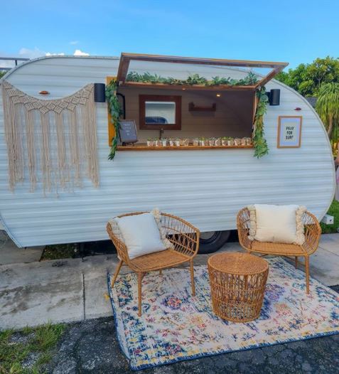 a retro camping trailer converted into a garden shed bar