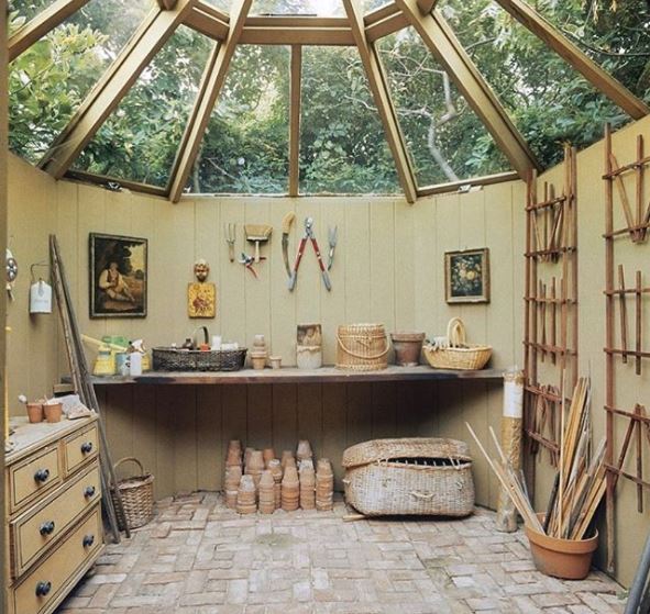 an octagonal garden potting shed with a glass roof