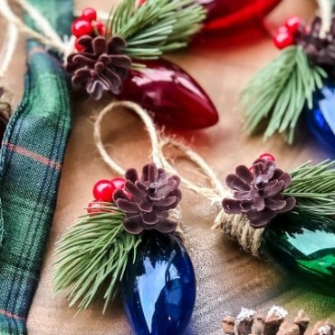 a string of vintage fairy lights with festive elements like pinecones and fir sprigs added
