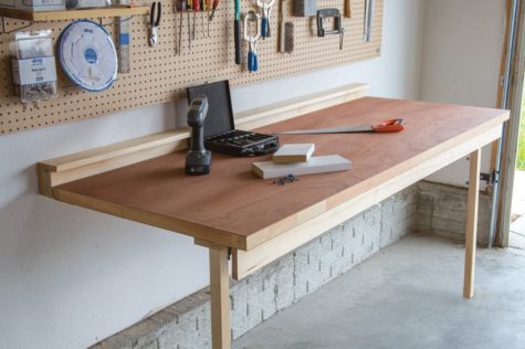 a shed workbench that can fold away thanks to a hinge on the wall